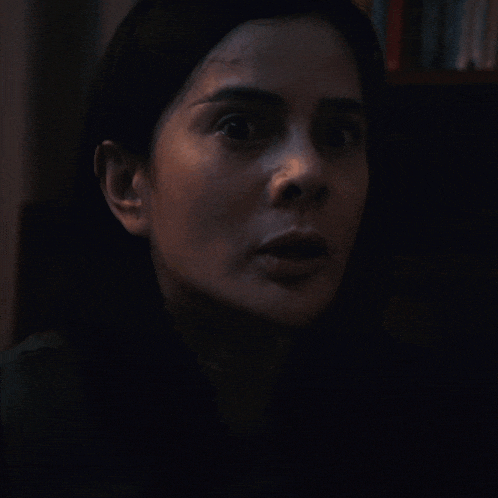 a close up of a woman 's face with a serious look on her face