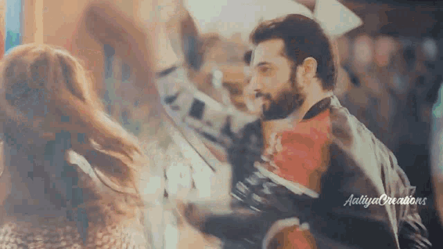 a man and a woman are dancing together in a blurry photo with the words aditya creations written on the bottom