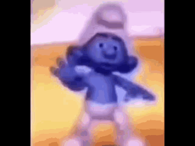a smurf is dancing in a blurred image .