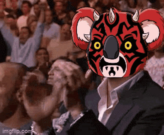 a man in a suit has a koala mask on his face
