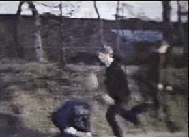 a man in a black shirt is kneeling on the ground