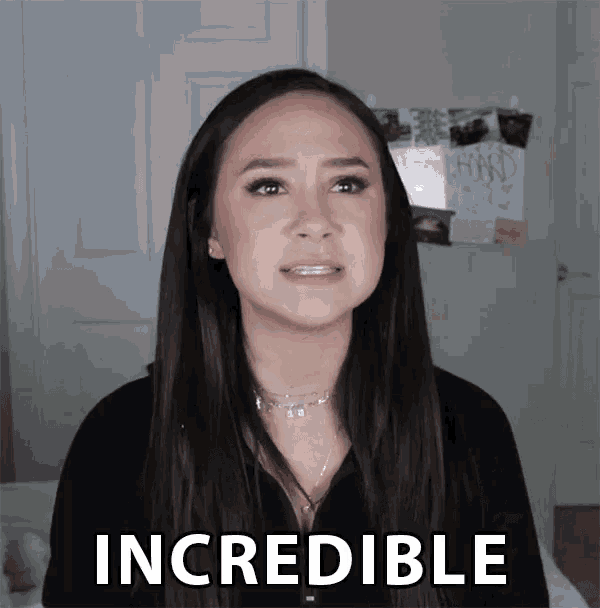 a woman with long hair is standing in front of a sign that says " incredible "
