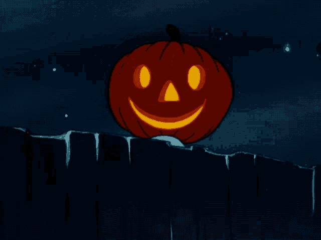 a pumpkin with a face carved into it is sitting on a fence