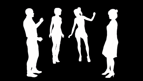 a group of people are standing next to each other and talking .