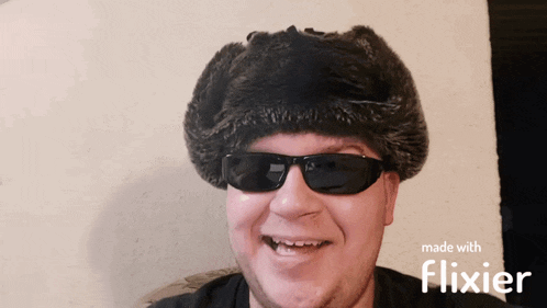 a man wearing sunglasses and a fur hat with the words made with flixier below him