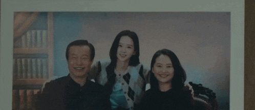 a group of people sitting on a couch with their arms around each other