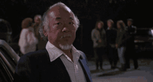 a man with a beard stands in front of a crowd
