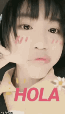 a close up of a person 's face with the word hola written on it .