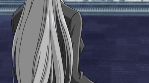 a woman with long gray hair is standing in front of a blue background