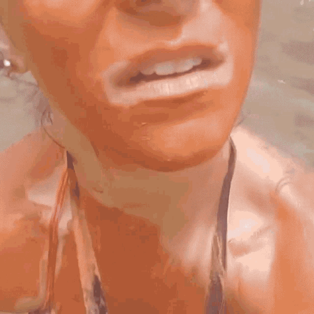 a close up of a woman 's face with a tear running down her face