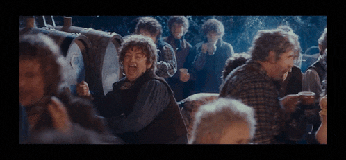 a group of men are standing around a barrel and one man is screaming