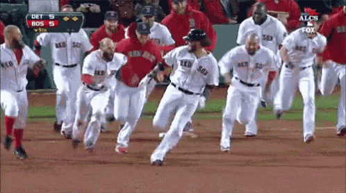 a group of boston red sox players are running on the field