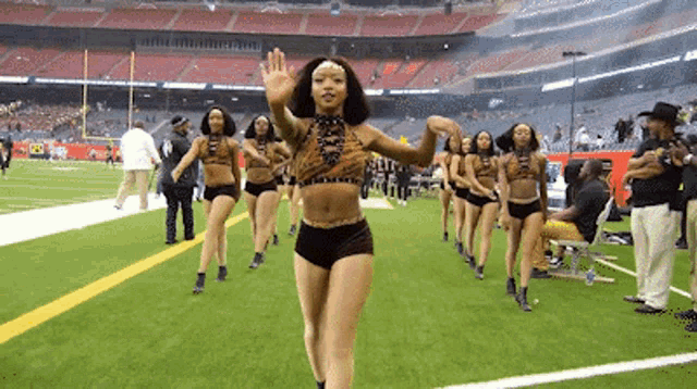 a group of cheerleaders are dancing on the field