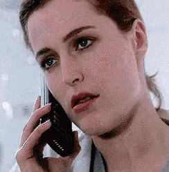 a woman is talking on a cell phone with a stethoscope around her neck