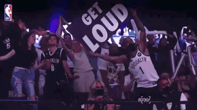 a brooklyn nets fan is dancing in front of a sign that says get loud