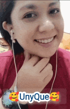 a woman wearing ear buds and a watch with the word unyque written on it