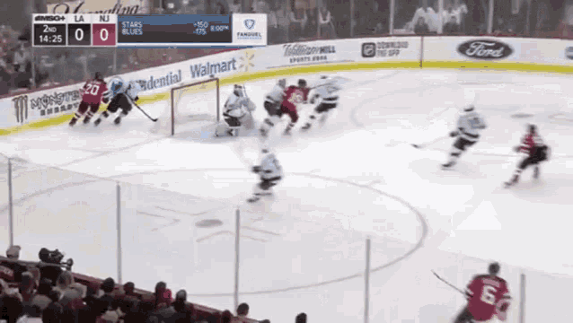 a hockey game is being played in front of a walmart banner