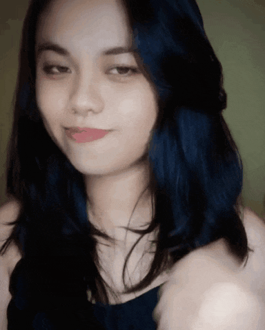 a close up of a woman with blue hair