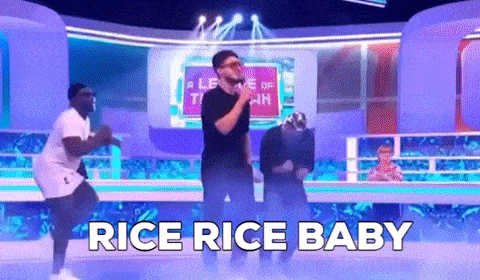 a group of men are dancing on a stage with the words `` rice rice baby '' behind them .