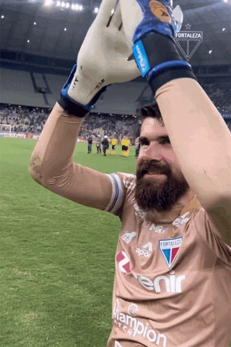 a man with a beard is wearing a shirt that says ' fortaleza ' on it
