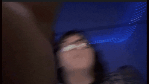 a close up of a person 's mouth with a purple background