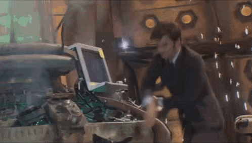 a man in a suit and tie is working on a machine