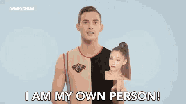 a man is holding a picture of ariana grande and says i am my own person .