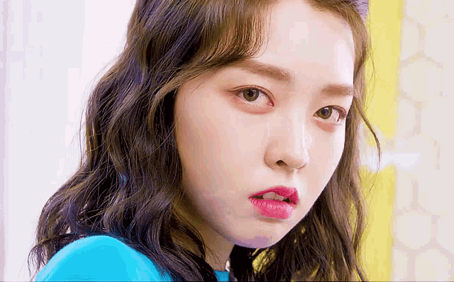 a close up of a woman 's face with pink lipstick on her lips