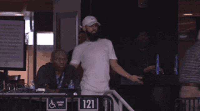 a man in a white shirt is dancing in front of a handicapped sign