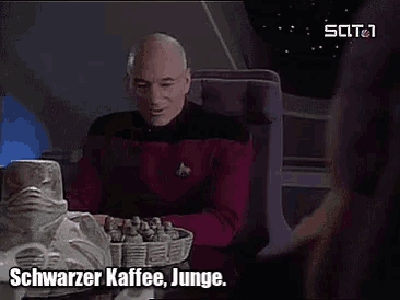 a man sitting at a table with the words schwarzer kaffee junge written on the bottom