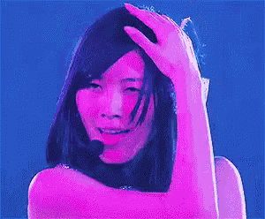 a woman is holding her hand to her forehead while wearing a microphone .