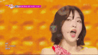 a woman is singing a song called touch my body on a stage