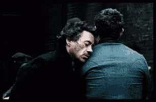 two men are standing next to each other and looking at each other .