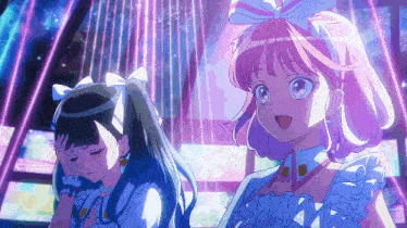 a girl with pink hair is standing next to another girl with black hair