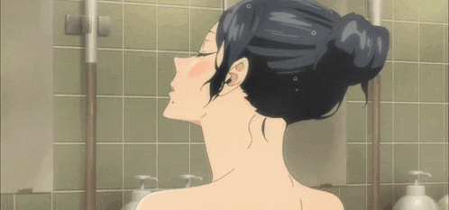 a woman is taking a bath in a bathroom with soap dispensers .