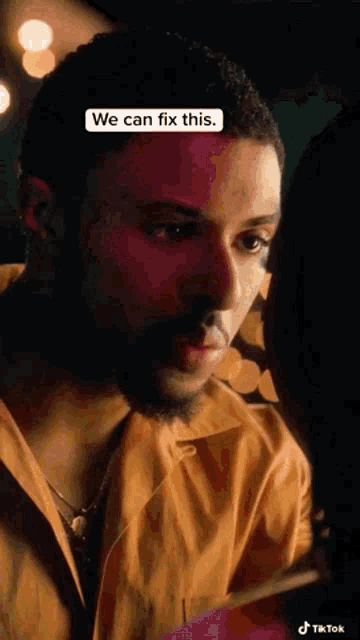 a man with a beard is looking at another man 's face and says we can fix this