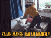 a man in a yellow shirt is kneeling on a bed with the words " kalah maneh kalah maneh !! " above him