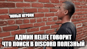 a man is standing in front of a brick wall with russian text on it