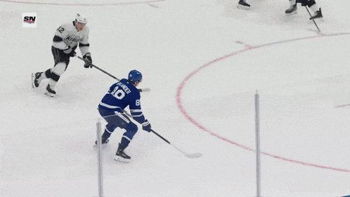 a hockey game is being played in front of a banner for scotiabank