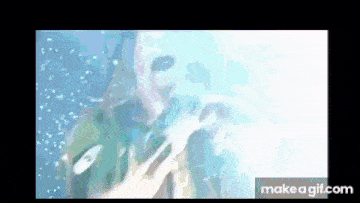 a close up of a person 's face in the water with bubbles coming out of it