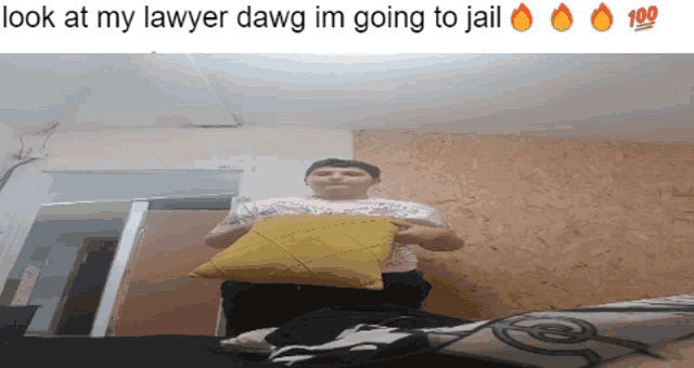 a man sitting on a bed holding a yellow pillow with the words look at my lawyer dawg im going to jail below him