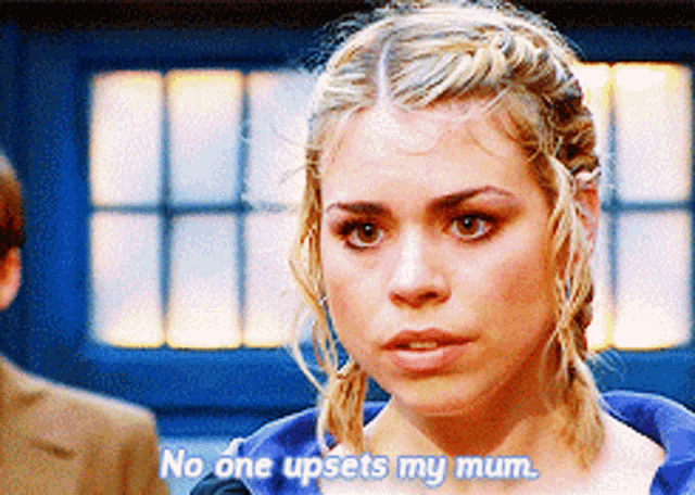 a woman says " no one upsets my mum " in front of a blue door