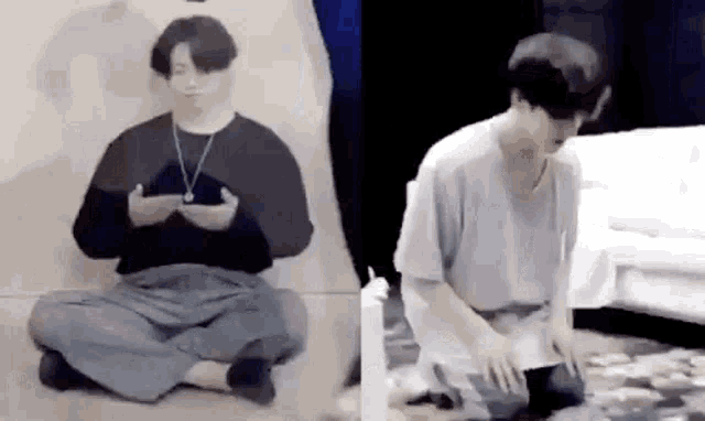 a man is sitting on the floor looking at his phone and another man is kneeling down and praying .