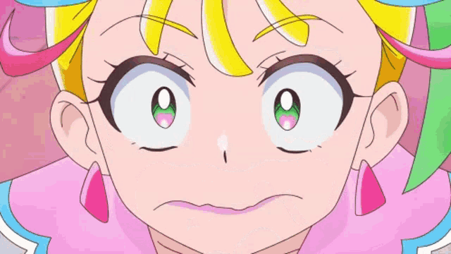 a close up of a girl 's face with a surprised look on her face .