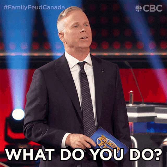 a man in a suit and tie is holding a clipboard that says what do you do