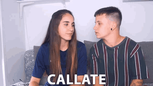 a man and a woman are looking at each other and the word callate is visible