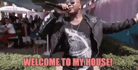a man is singing into a microphone with the words welcome to my house written below him