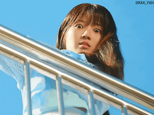 a woman looking over a railing with the watermark drxx_yxh on the bottom