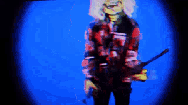a blurry image of a person holding a gun with a blue background