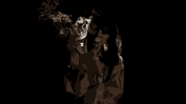 a woman smoking a cigarette in the dark with smoke coming out of her mouth